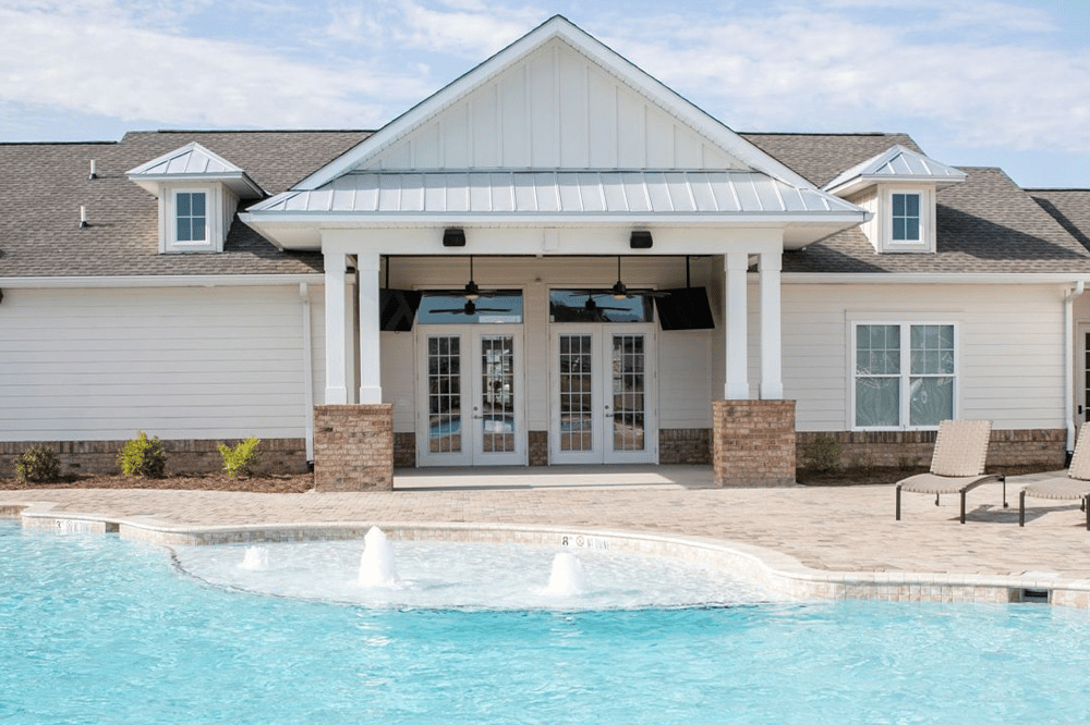 Luxury apartment amenities in the form of a resort-style pool and clubhouse